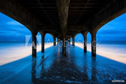 Picture of Twilight dusk landscape of pier stretching out into sea with moo